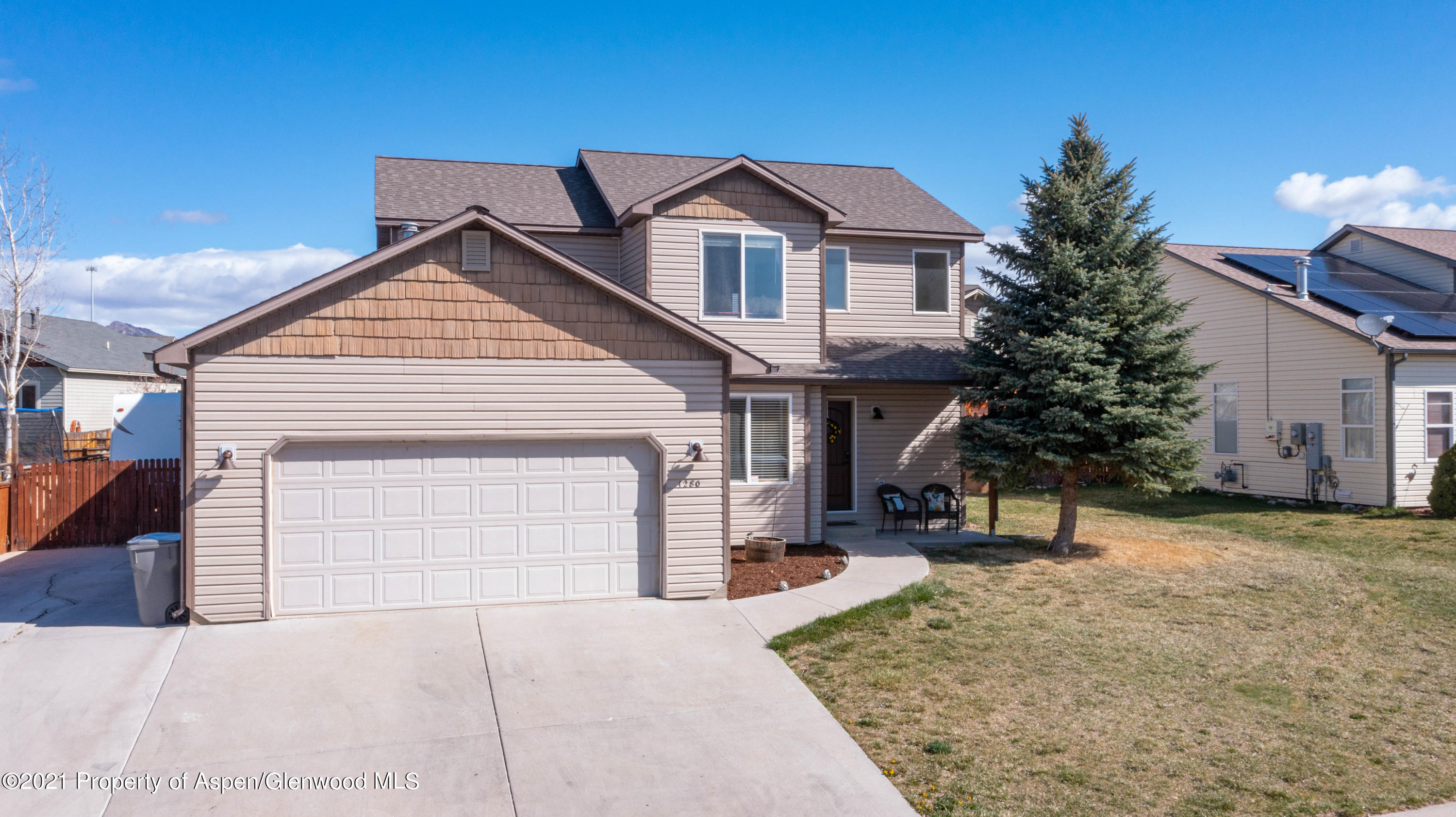 1280 East 18th Way Rifle, CO 81650 - Photo 2 of 18 a front view of a house with a yard and garage