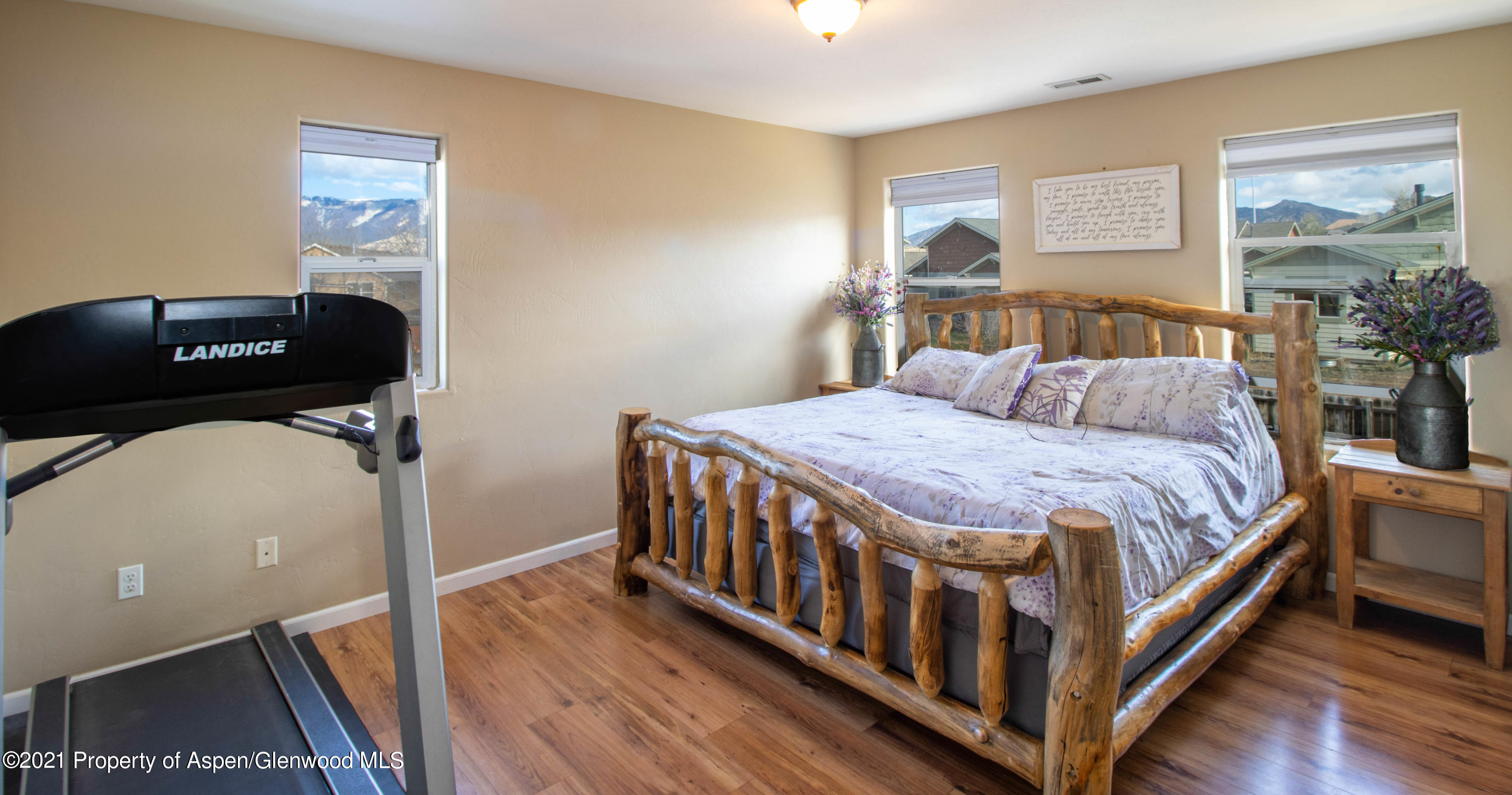 1280 East 18th Way Rifle, CO 81650 - Photo 8 of 18 a bedroom with a bed and wooden floor