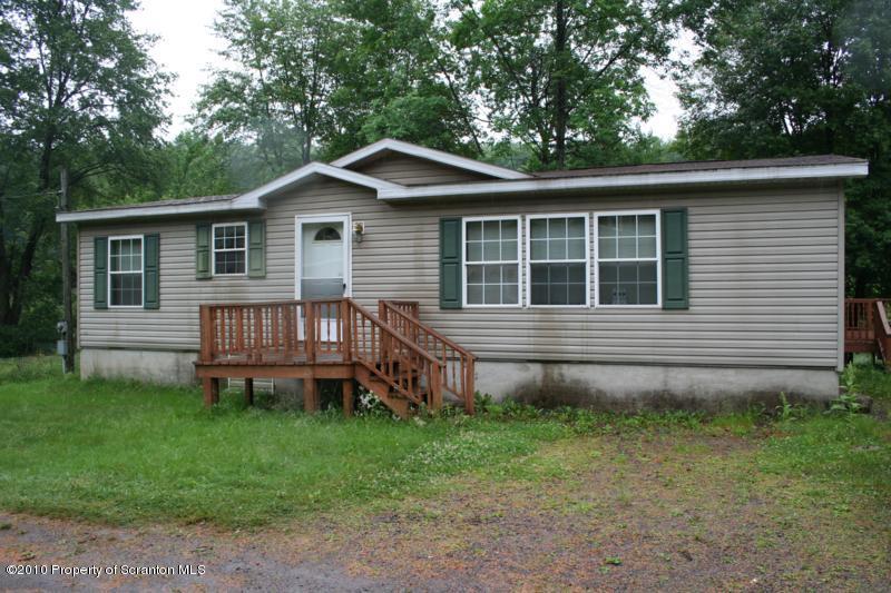 351 R Casterline Road Dallas, PA 18612 - Photo 1 of 13 a backyard of a house with wooden deck and barbeque oven