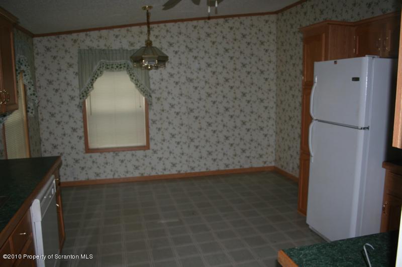 351 R Casterline Road Dallas, PA 18612 - Photo 4 of 13 a bathroom with a granite countertop shower a sink and a mirror