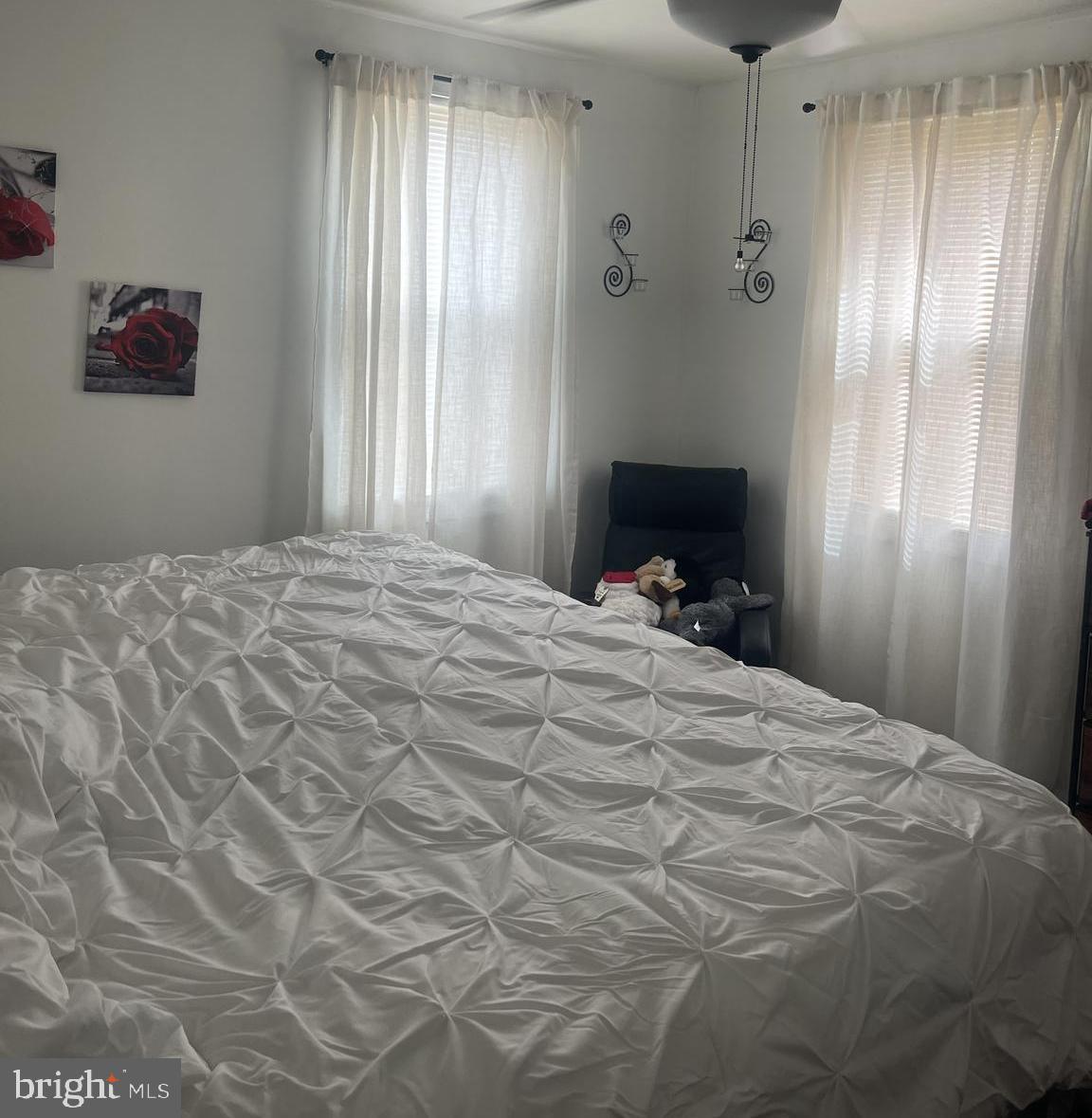 70 Del Rio Road Baltimore, MD 21222 - Photo 12 of 40 a large bedroom with a bed and a chandelier