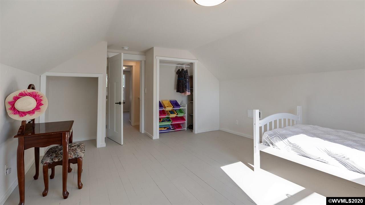 790 Southeast Fir Villa Road Dallas, OR 97338 - Photo 28 of 38 a bedroom with furniture and a chandelier