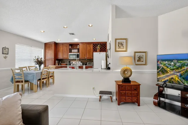a kitchen with stainless steel appliances kitchen island granite countertop a sink and cabinets