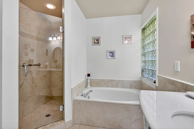 a bathroom with a bathtub and shower