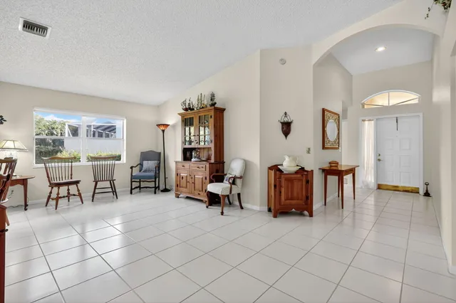 a living room with furniture and a dining table