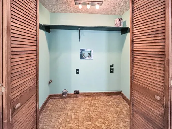 a view of a hallway to a room with a door