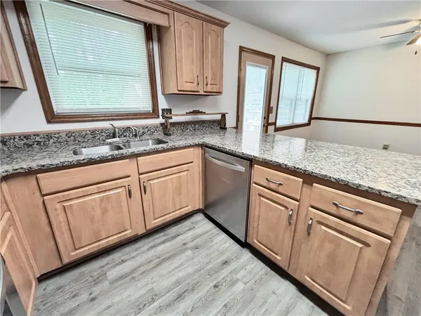 a kitchen with granite countertop white cabinets and white appliances