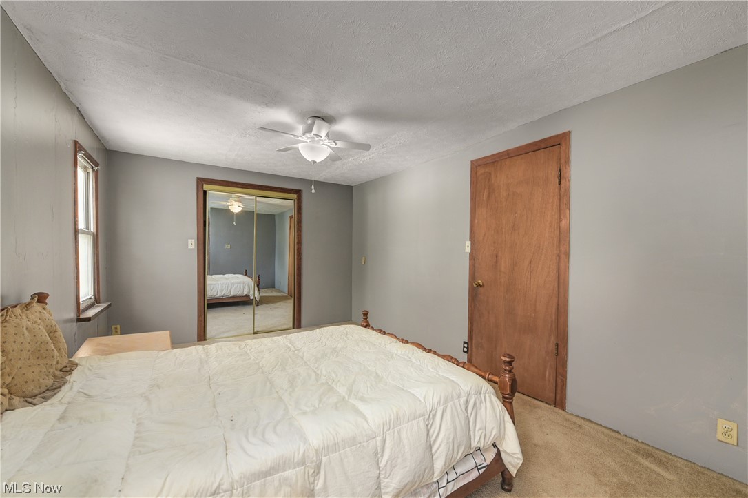 4709 Snow Road Cleveland, OH 44134 - Photo 17 of 35 2nd Bedroom with ceiling fan, a closet, carpet, and a textured ceiling