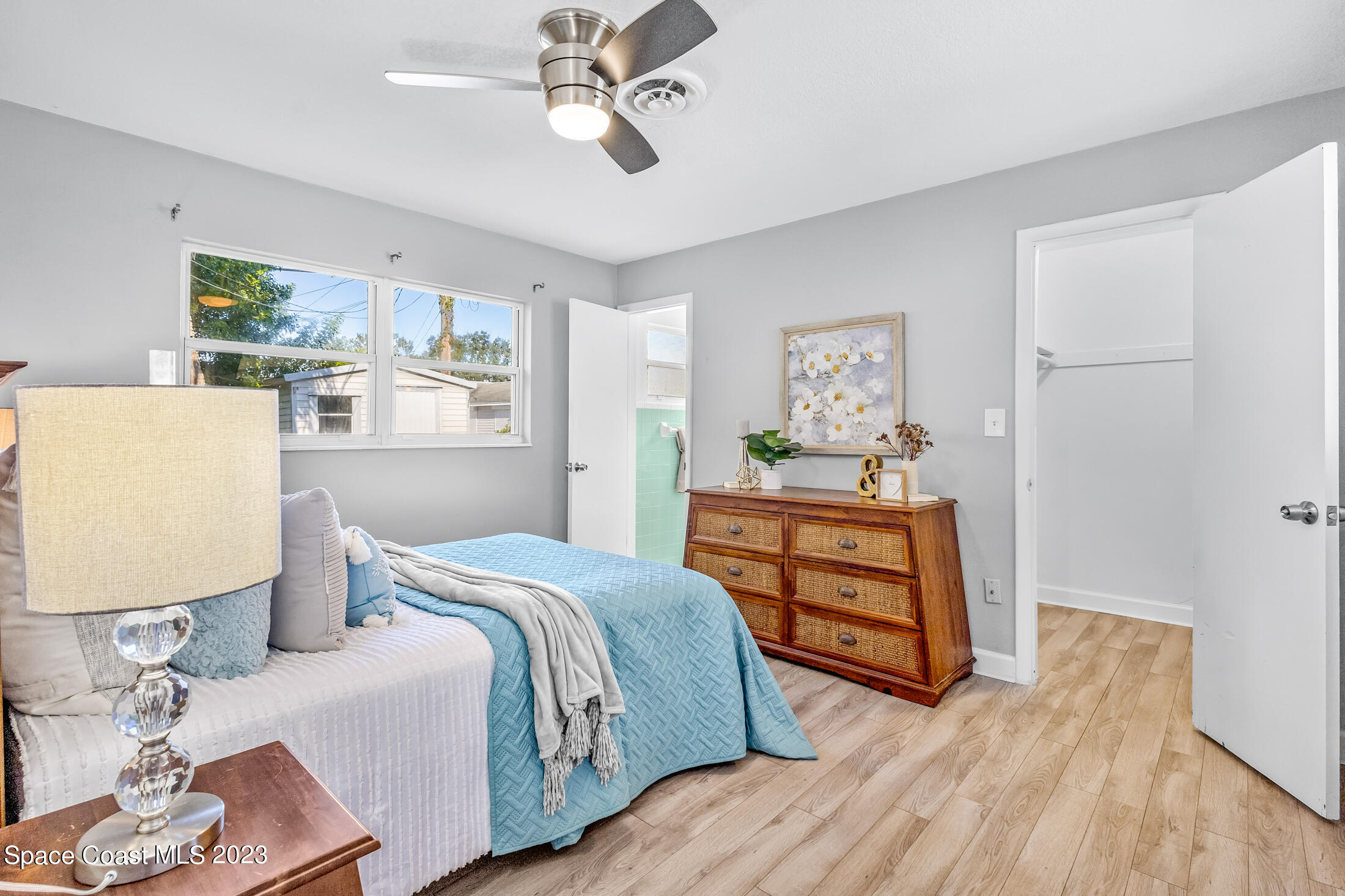696 Teak Drive Melbourne, FL 32935 - Photo 11 of 22 a bedroom with a bed and wooden floor