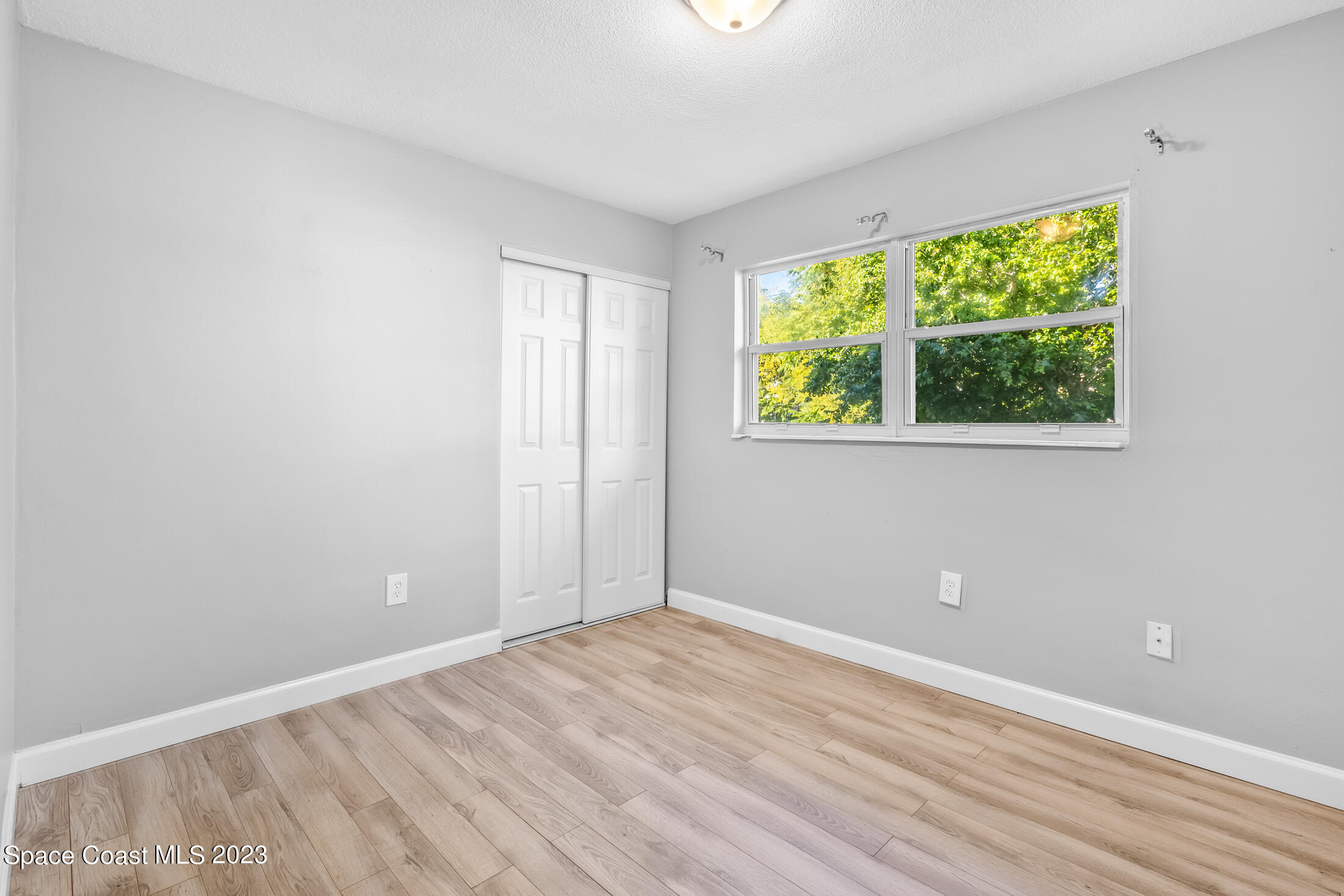696 Teak Drive Melbourne, FL 32935 - Photo 14 of 22 a view of room with window and hardwood floor