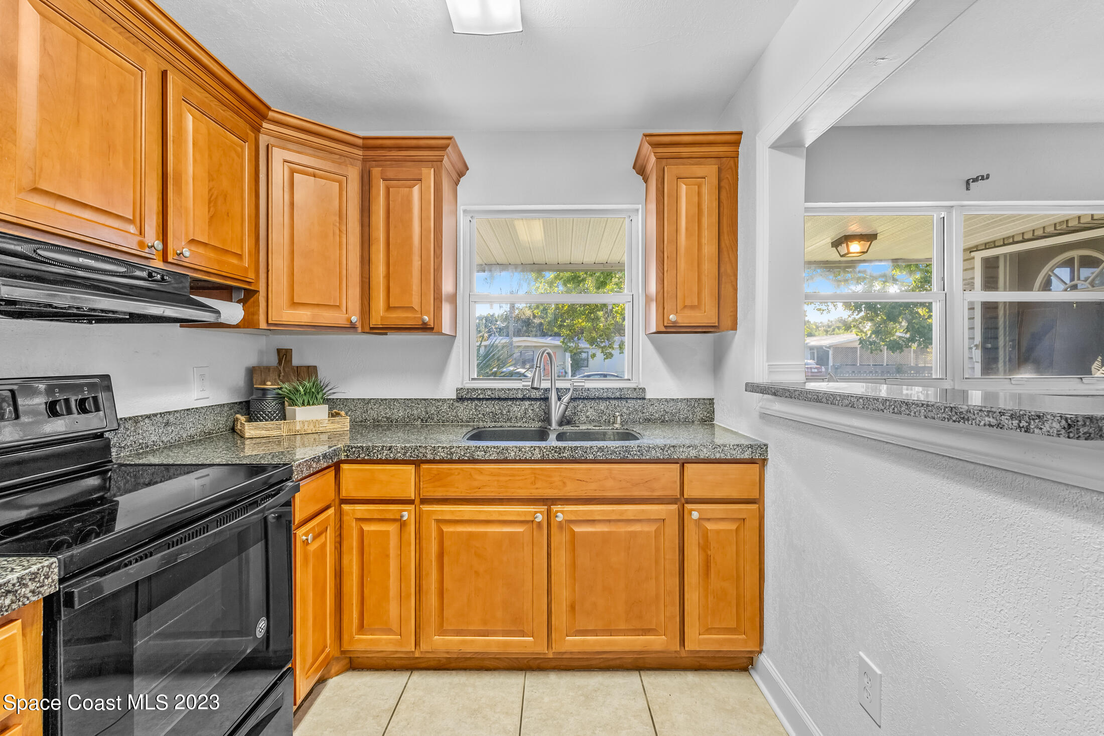696 Teak Drive Melbourne, FL 32935 - Photo 19 of 22 a kitchen with stainless steel appliances granite countertop a sink stove and cabinets