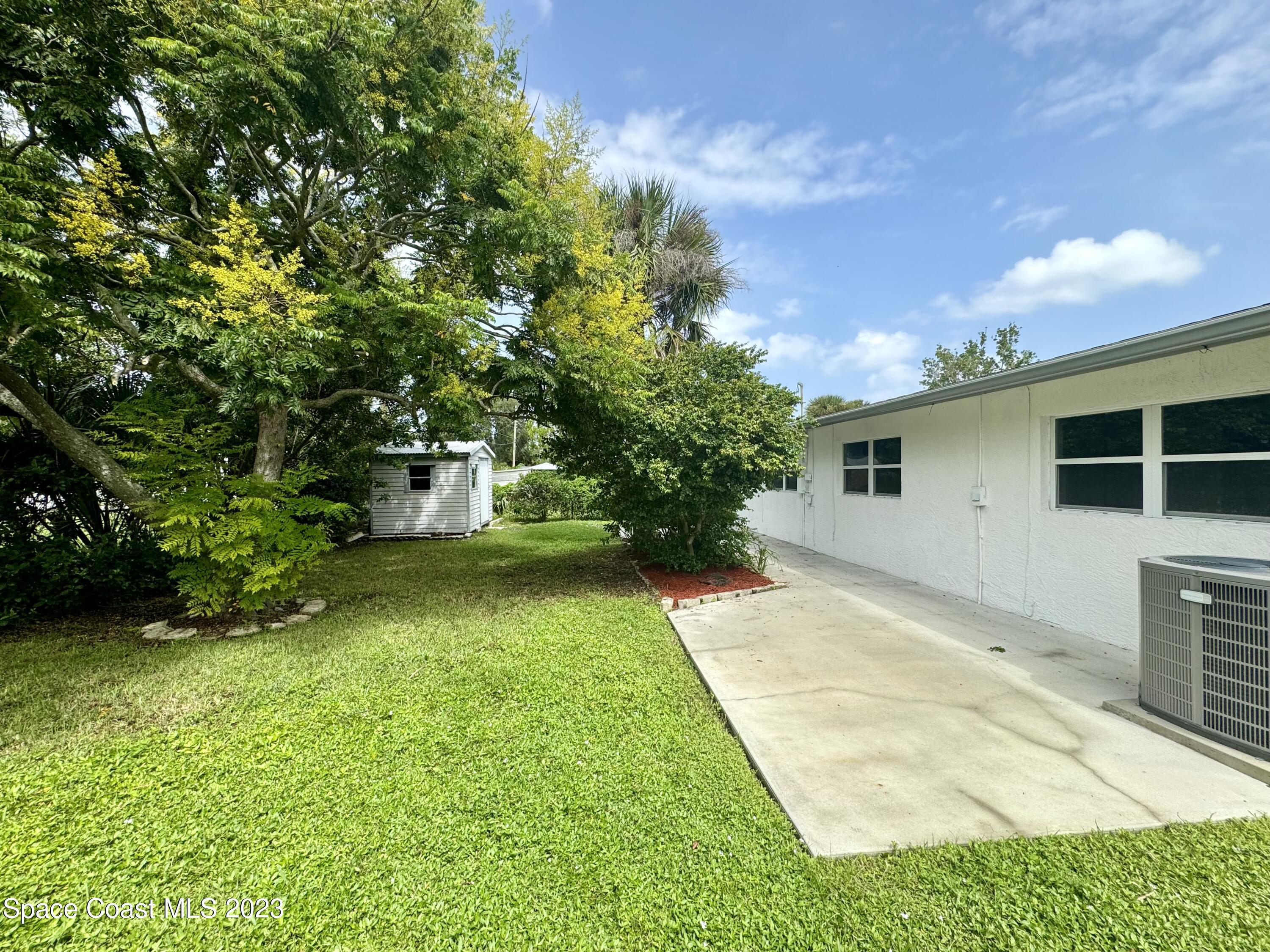 696 Teak Drive Melbourne, FL 32935 - Photo 21 of 22 a front view of a house with garden