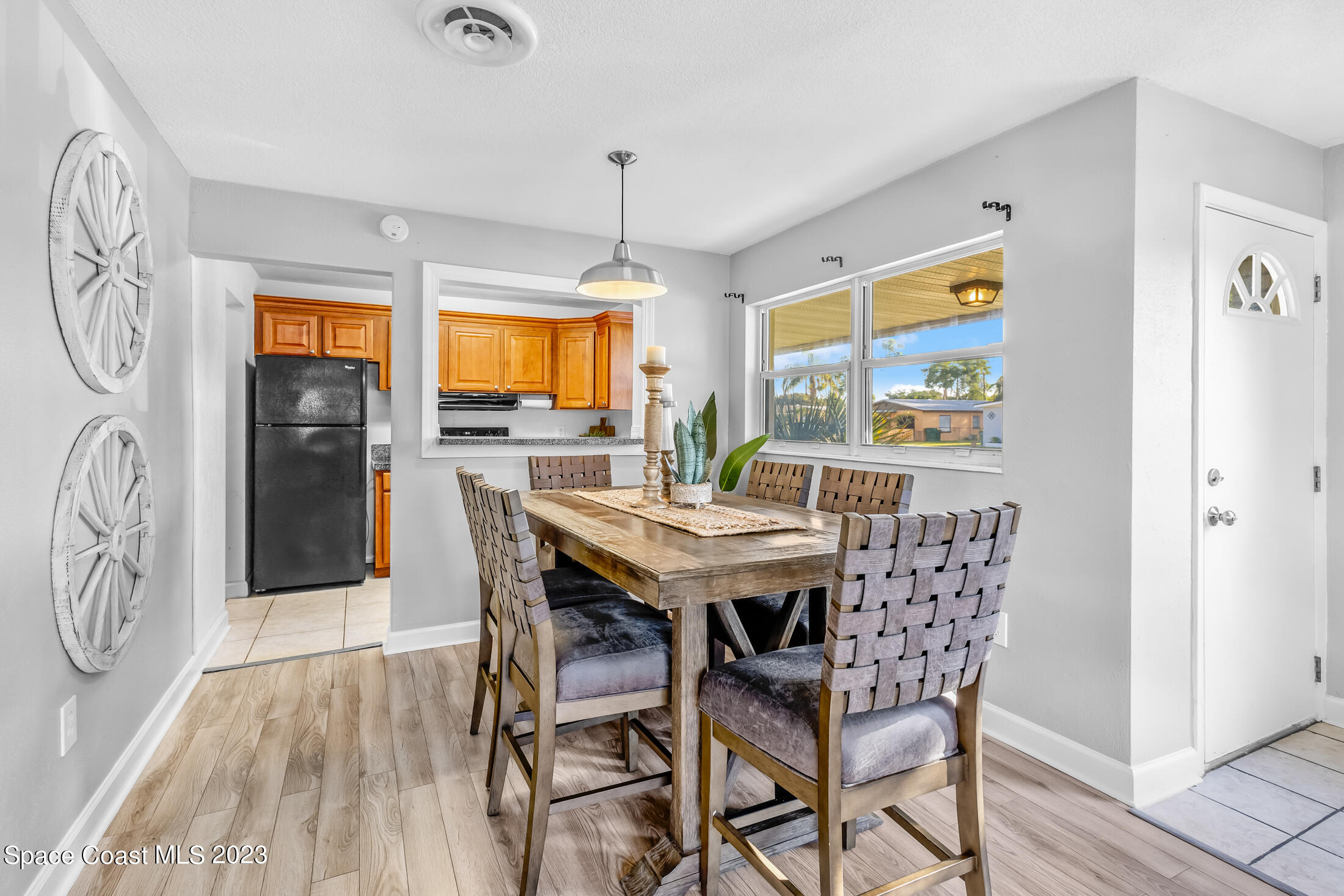 696 Teak Drive Melbourne, FL 32935 - Photo 5 of 22 a view of a dining room with furniture window and wooden floor