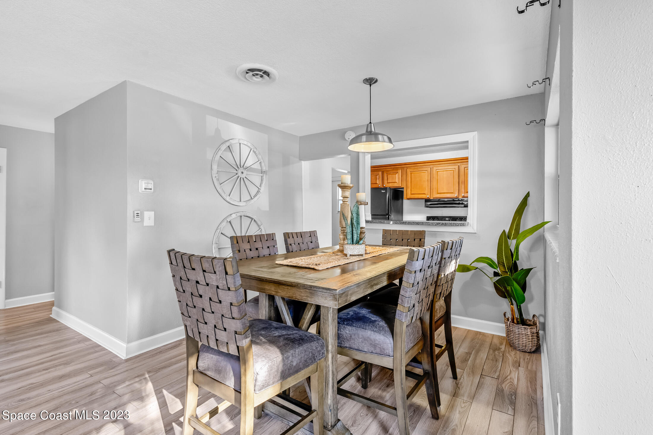 696 Teak Drive Melbourne, FL 32935 - Photo 6 of 22 a view of a dining room with furniture and chandelier