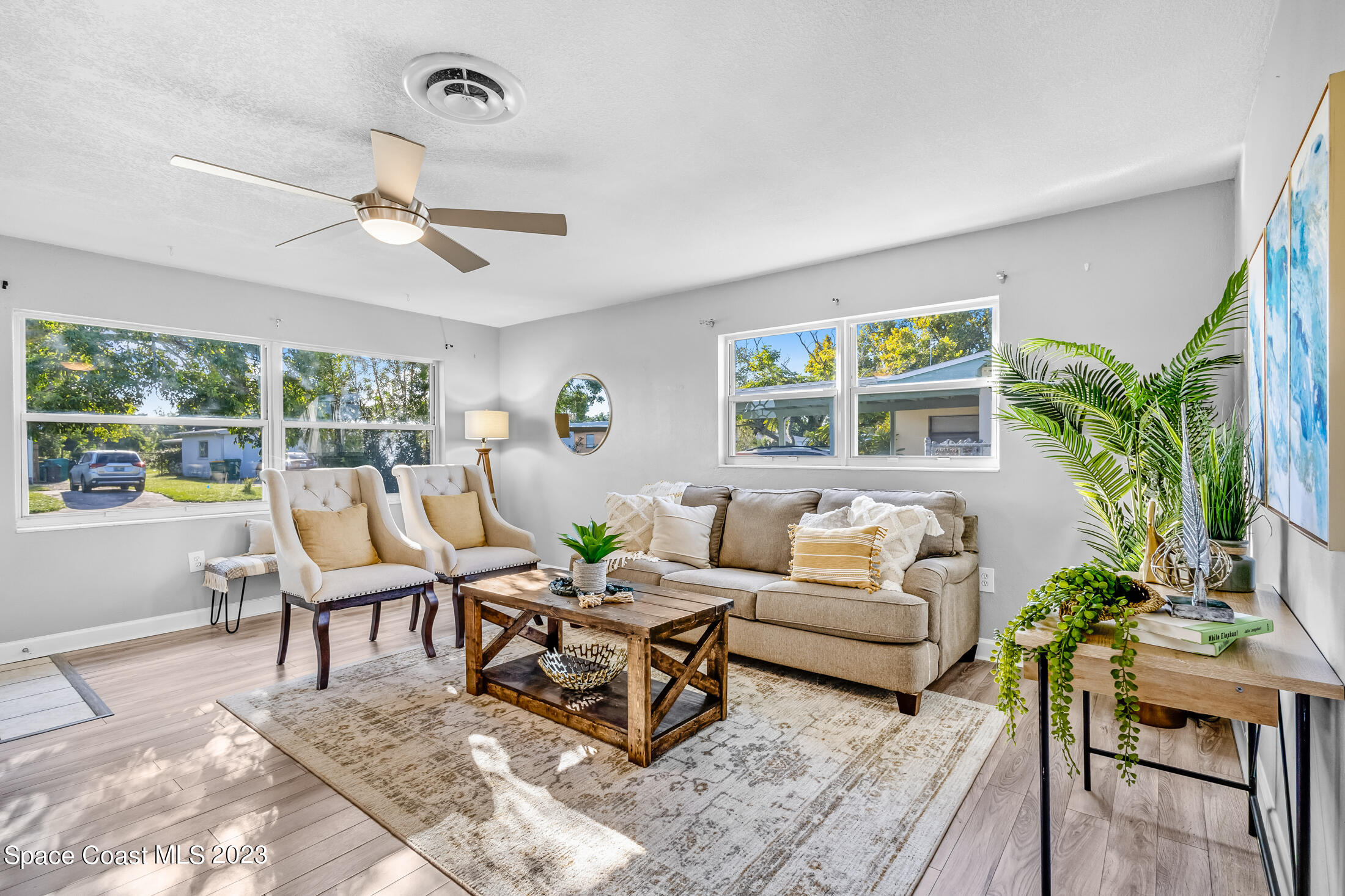 696 Teak Drive Melbourne, FL 32935 - Photo 8 of 22 a living room with furniture ceiling fan and a window