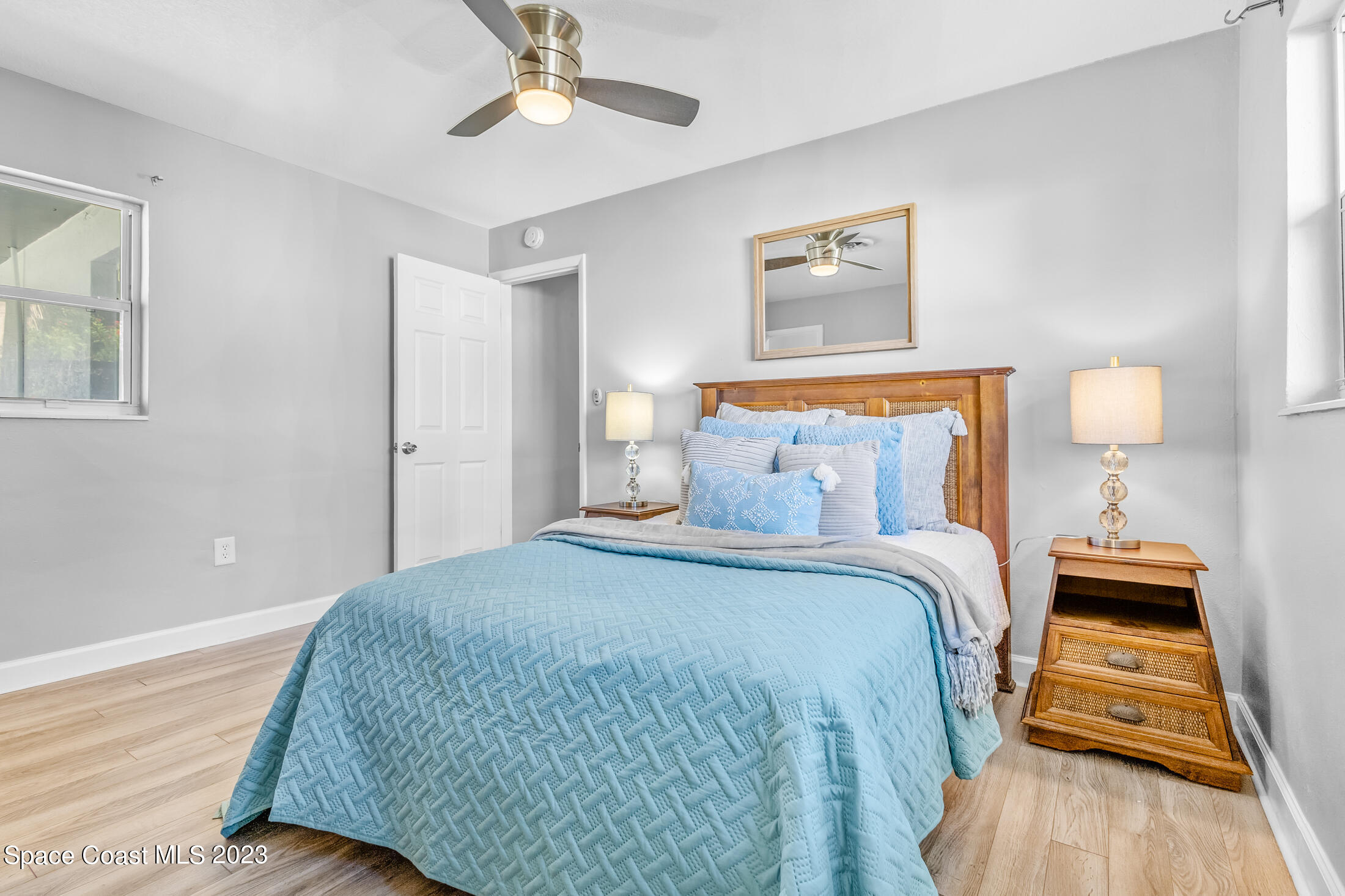 696 Teak Drive Melbourne, FL 32935 - Photo 10 of 22 a bedroom with a bed and wooden floor