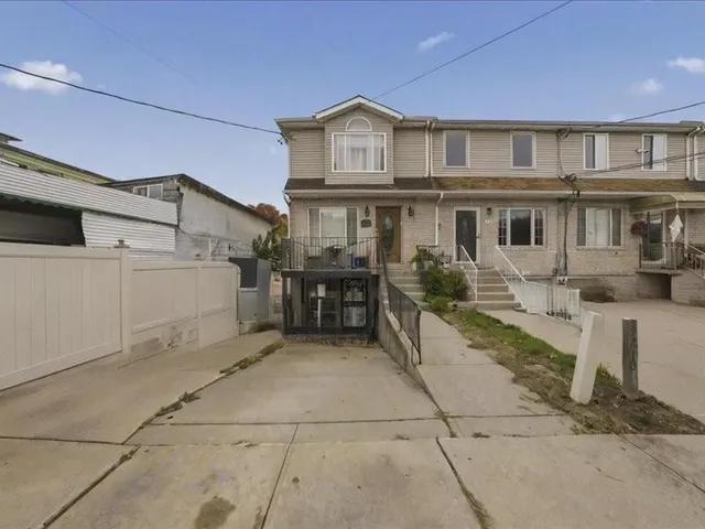 a view of a white house with large windows and a table
