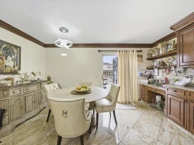 a view of kitchen with sink and chairs