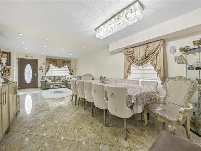 a living room with furniture a table and chairs