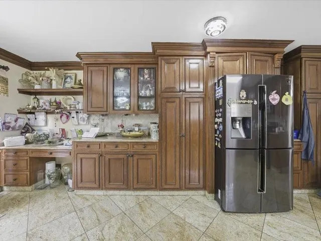 a kitchen with stainless steel appliances granite countertop a refrigerator and a sink