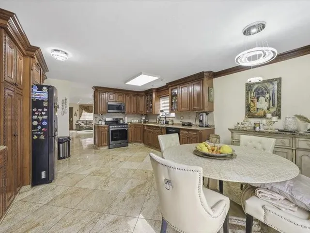 a kitchen with a table and chairs in it
