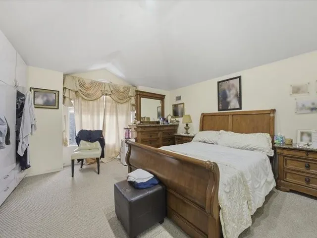 a bedroom with a bed and a couch