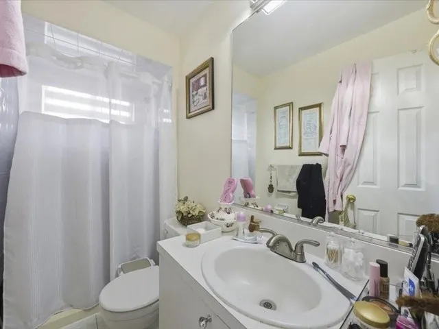 a bathroom with a sink toilet and mirror