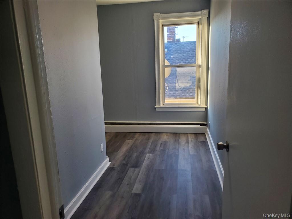 76 State Street, Unit 10 Ossining, NY 10562 - Photo 11 of 23 a view of an empty room with wooden floor and a window