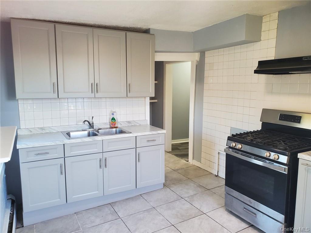76 State Street, Unit 10 Ossining, NY 10562 - Photo 19 of 23 a kitchen with a stove and a refrigerator