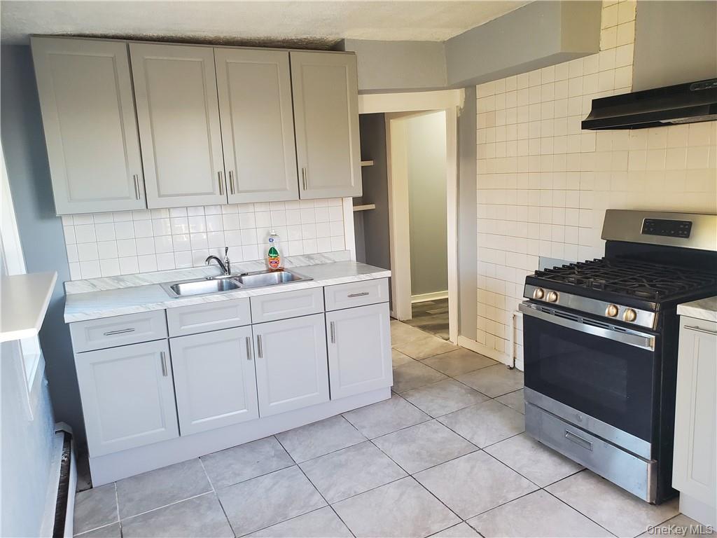 76 State Street, Unit 10 Ossining, NY 10562 - Photo 4 of 23 a kitchen with white cabinets and white appliances