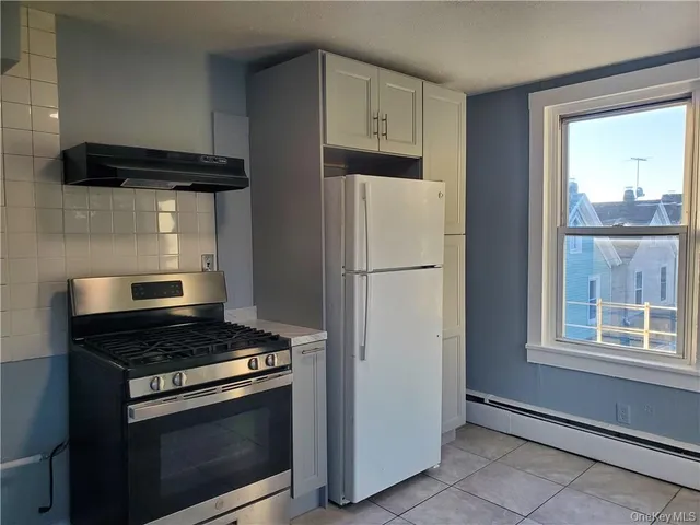 a kitchen with stainless steel appliances a refrigerator and a stove top oven