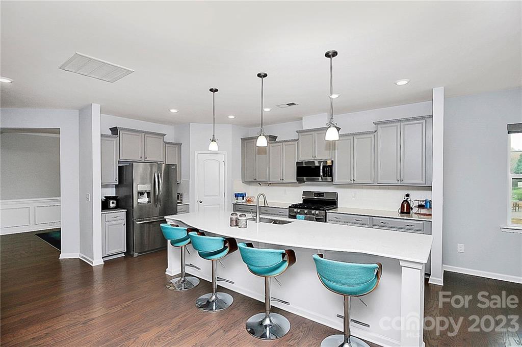 227 Houston Blair Road Matthews, NC 28104 - Photo 15 of 39 a kitchen with refrigerator and chairs