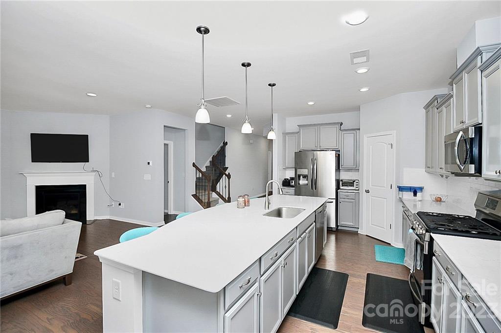 227 Houston Blair Road Matthews, NC 28104 - Photo 17 of 39 a large kitchen with kitchen island a sink appliances and a counter top space