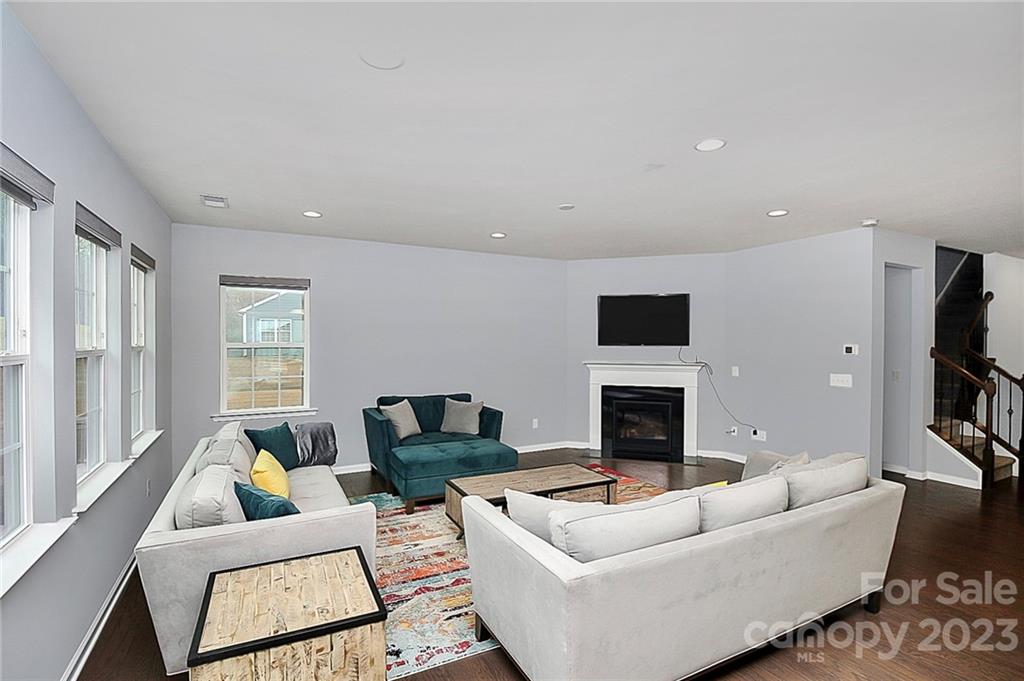 227 Houston Blair Road Matthews, NC 28104 - Photo 19 of 39 a living room with furniture a fireplace and a flat screen tv