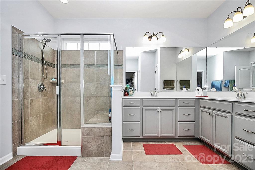 227 Houston Blair Road Matthews, NC 28104 - Photo 27 of 39 a spacious bathroom with a tub shower and sink