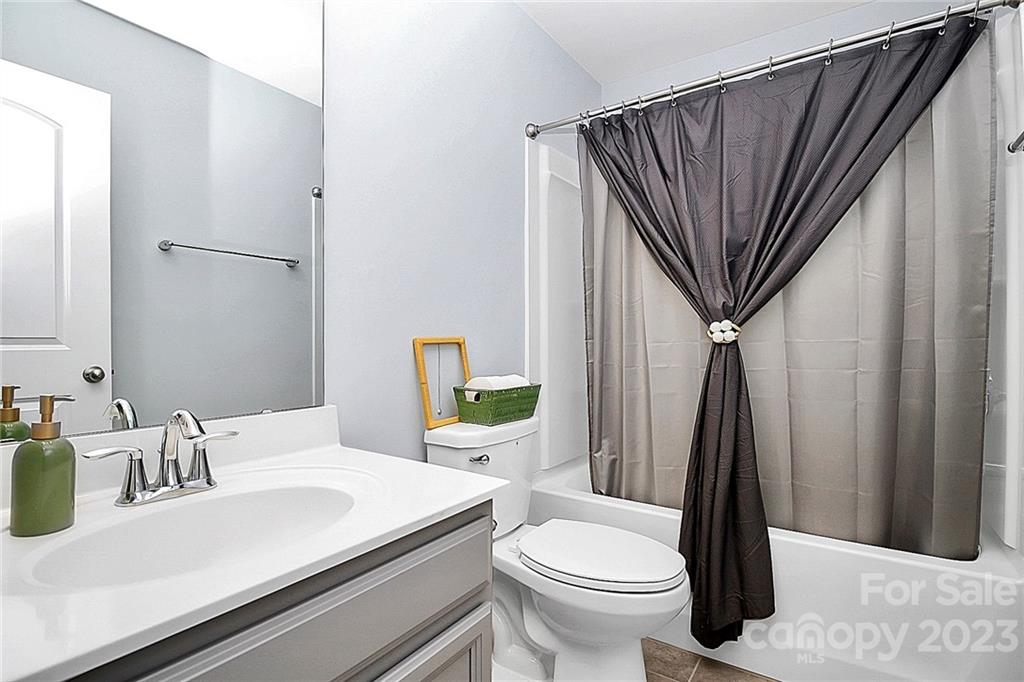 227 Houston Blair Road Matthews, NC 28104 - Photo 32 of 39 a bathroom with a sink a toilet a mirror and shower