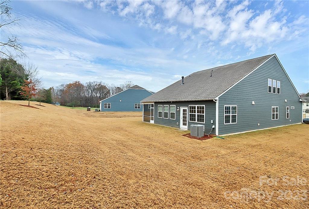 227 Houston Blair Road Matthews, NC 28104 - Photo 37 of 39 a front view of house with yard and trees in the background