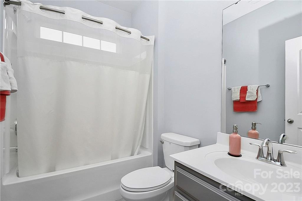 227 Houston Blair Road Matthews, NC 28104 - Photo 10 of 39 a white toilet sitting next to a bathroom sink