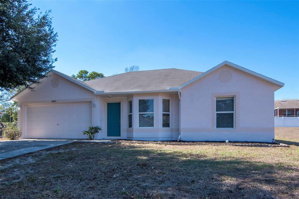5051 Teather Street Spring Hill, FL 34608 - Photo 1 of 1 a front view of a house with a yard