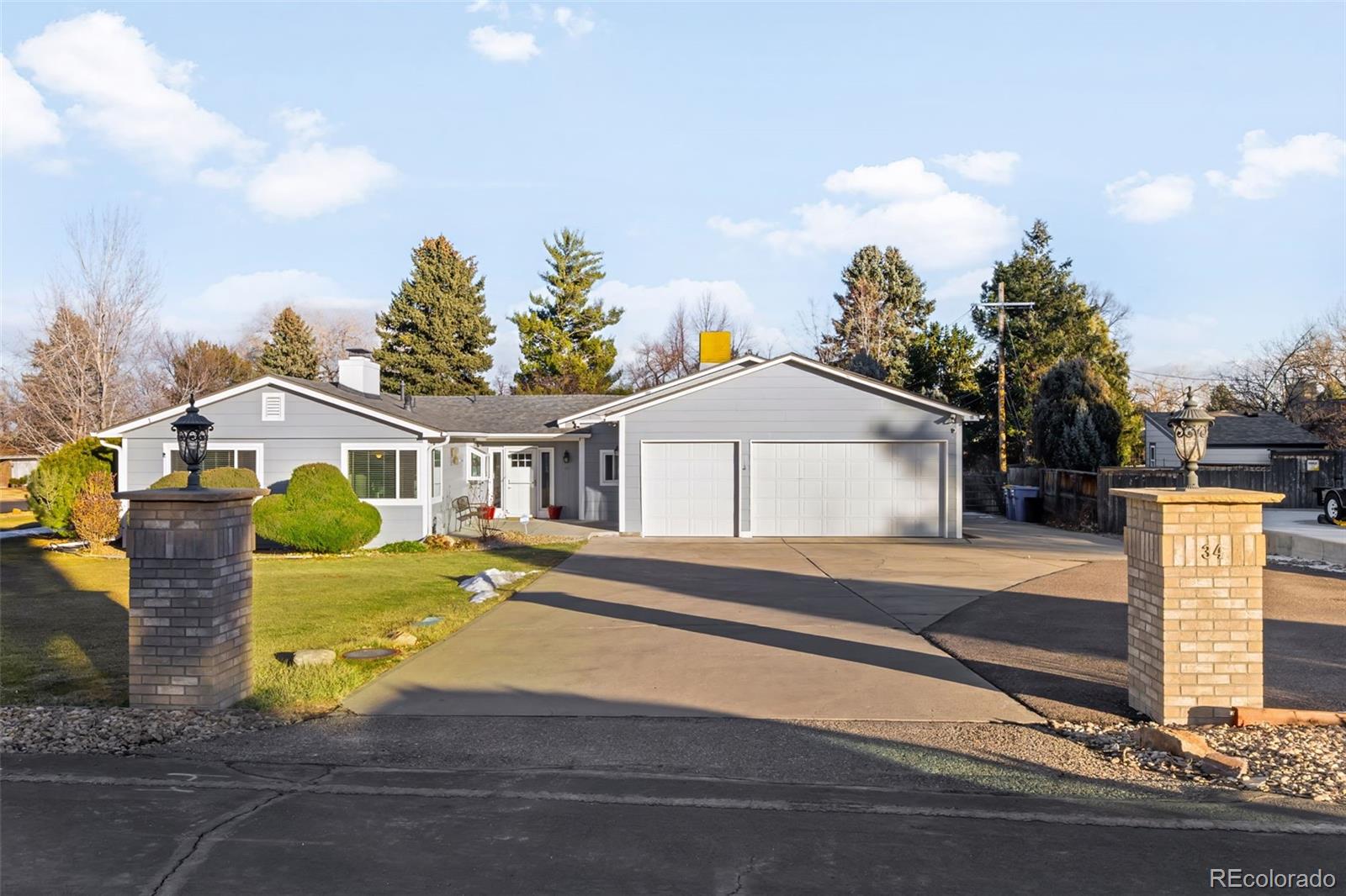 34 Skyline Drive Wheat Ridge, CO 80215 - Photo 35 of 45 a front view of a house with a yard and garage