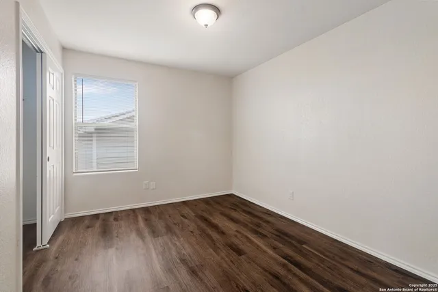 a view of wooden floor in an empty room