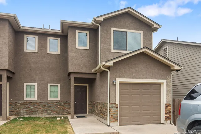 a front view of a house with a garage