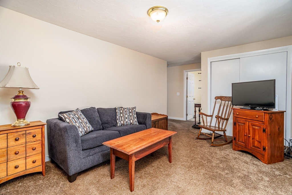 113 Parker Road, Unit 1 Lancaster, MA 01523 - Photo 12 of 30 a living room with furniture and a flat screen tv