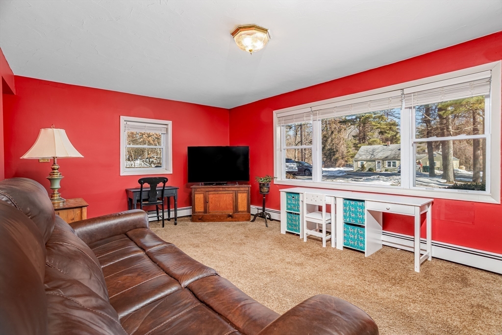 113 Parker Road, Unit 1 Lancaster, MA 01523 - Photo 16 of 30 a living room with furniture and a flat screen tv