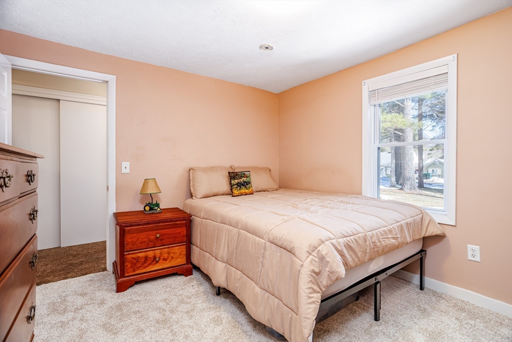 113 Parker Road, Unit 1 Lancaster, MA 01523 - Photo 18 of 30 a bedroom with a bed and a window