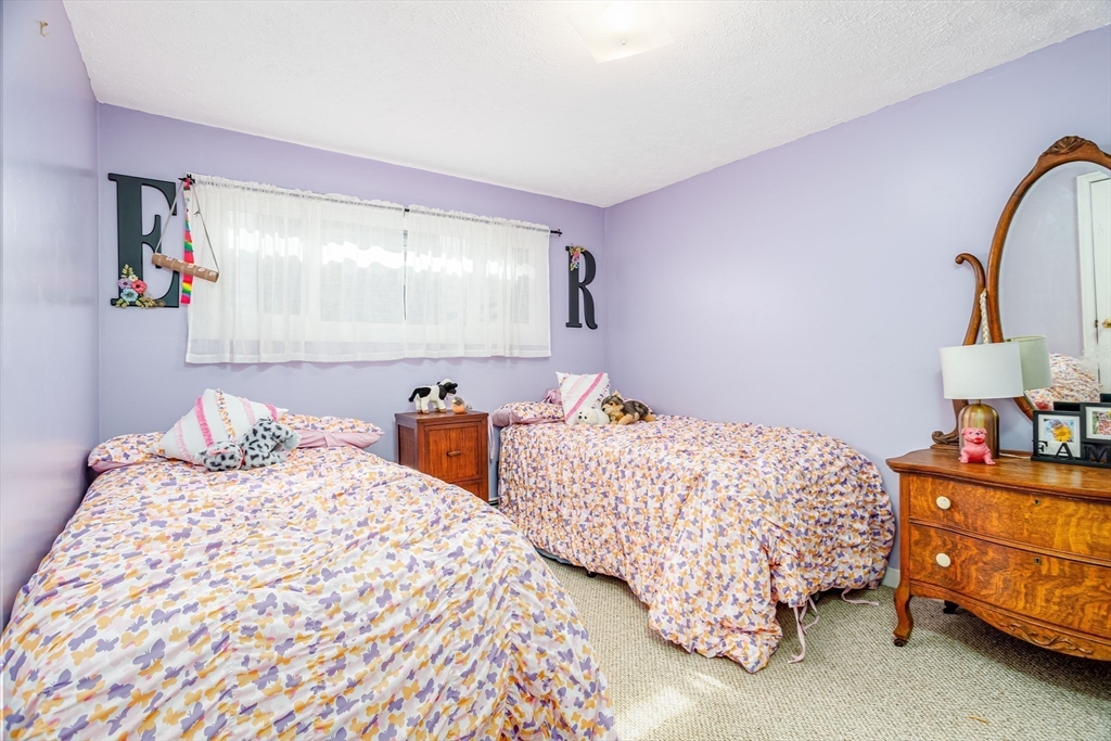 113 Parker Road, Unit 1 Lancaster, MA 01523 - Photo 21 of 30 a bedroom with two beds and a lamp on dresser