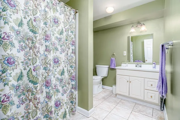 a spacious bathroom with a sink toilet and shower