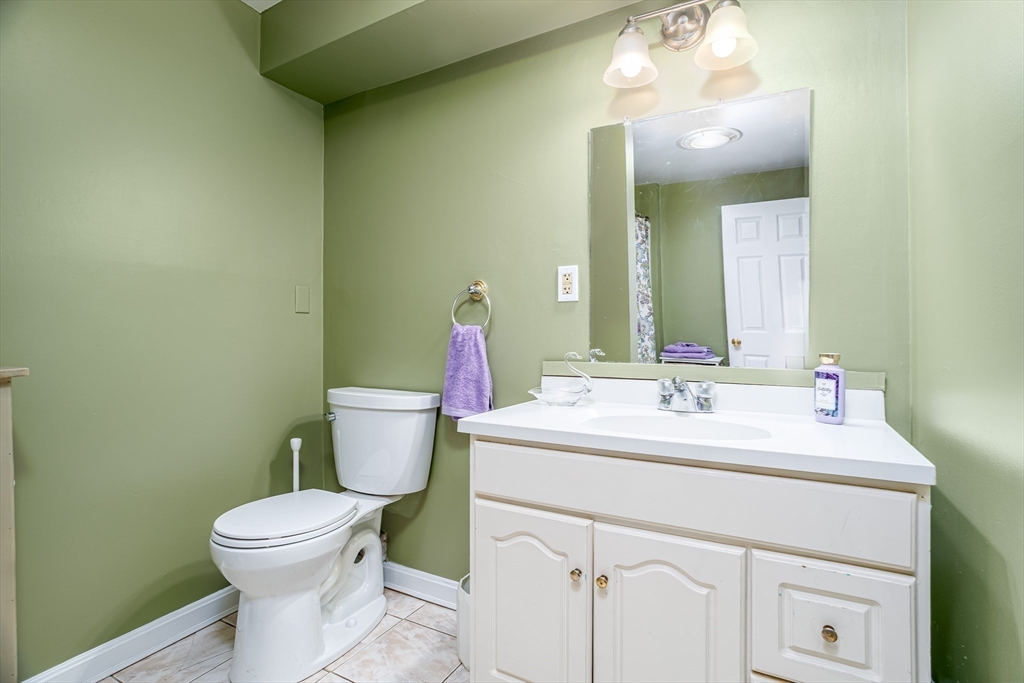 113 Parker Road, Unit 1 Lancaster, MA 01523 - Photo 24 of 30 a bathroom with a toilet sink and mirror