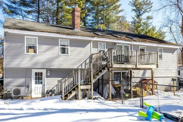 a front view of a house with a tree