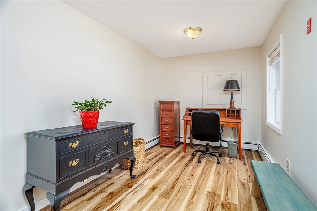 113 Parker Road, Unit 1 Lancaster, MA 01523 - Photo 4 of 30 a living room with a furniture and a flat screen tv